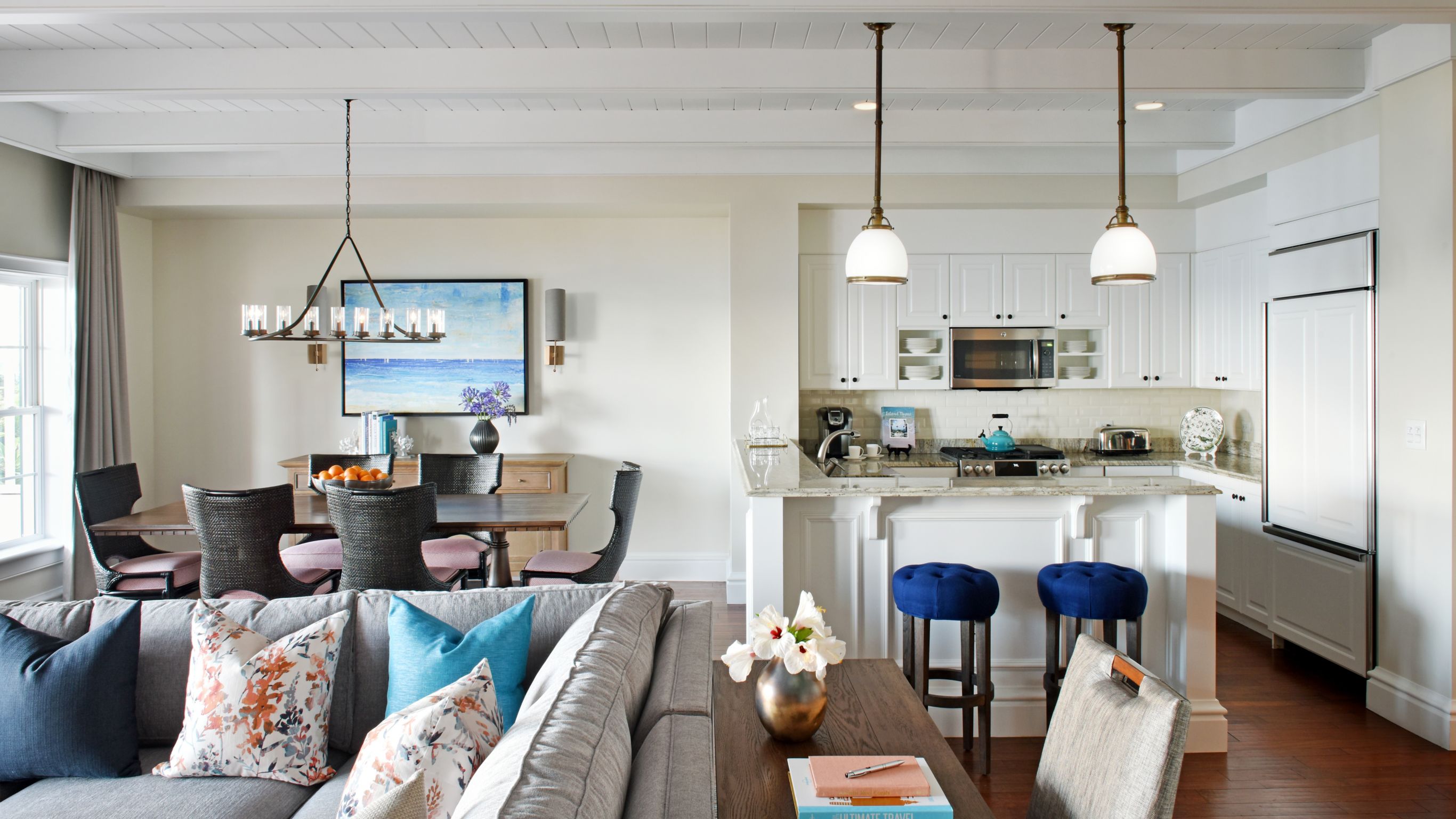 Residence desk and sofa foreground kitchen to right dining table left